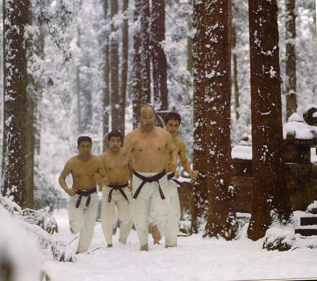 Mas Oyama leads a group of Kyokushin practitioners on a run in the snow during a winter camp.