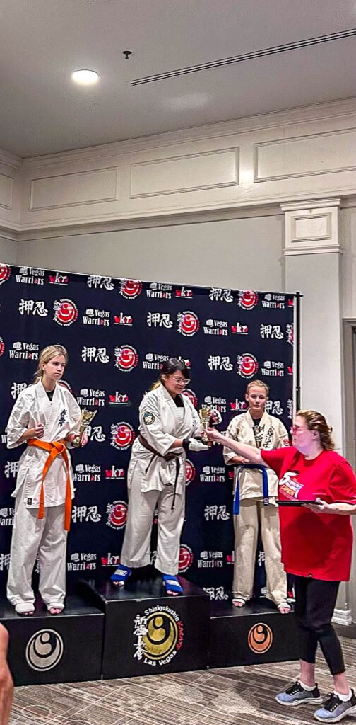 Karina Moreno receiving her 1st-place trophy at the 6th All-American Full-Contact Championships