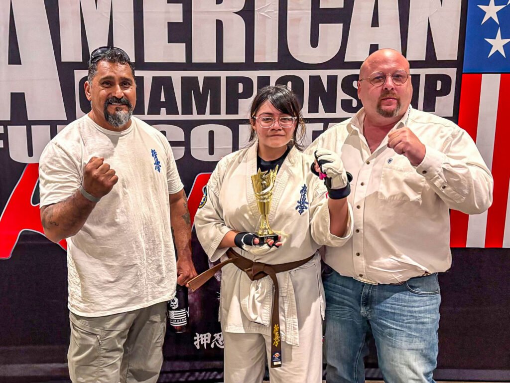 Karina Moreno with Sensei Omar Covarrubias and Shihan Bill Schrader after winning 1st place at the 6th All-American Full-Contact Championships