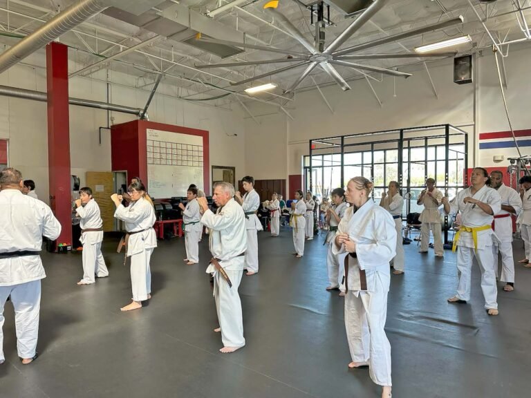 Kyokushin karate practitioners lined up in rows preparing to train during the Knockdown Fighting Seminar at Kaizen Kan Dojo in Tucson, Arizona.